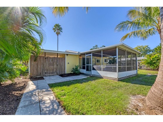 Beachy sandy area with firepit and insulated, airconditioned shed at 2102 Dakota Ave. Englewood FL 34224 - Single Family Home for sale at 2102 Dakota Ave, Englewood, FL 34224 - MLS Number is D6121750