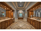 Master Bathroom with Luxurious Tile Detailing Throughout - Single Family Home for sale at 8499 Lindrick Ln, Bradenton, FL 34202 - MLS Number is A4475594
