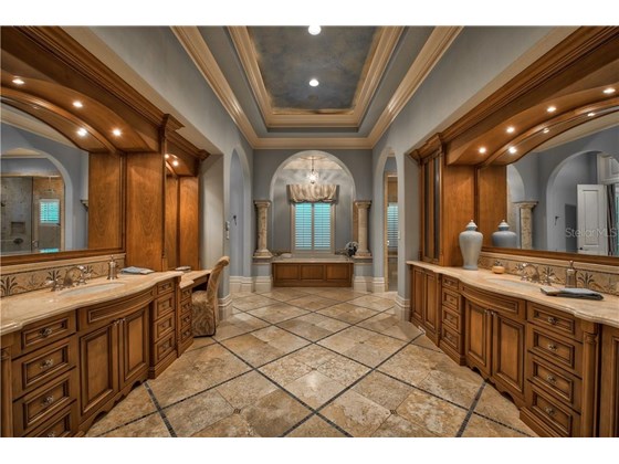 Master Bathroom with Luxurious Tile Detailing Throughout - Single Family Home for sale at 8499 Lindrick Ln, Bradenton, FL 34202 - MLS Number is A4475594