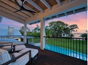 The private balcony made of Ipe wood offers an elevated space to enjoy Palma Sola Bay sunsets. - Single Family Home for sale at Address Withheld, Bradenton, FL 34209 - MLS Number is A4509547