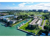 South west views of Bay Harbour.  Longboat Key Club Golf Court across Gulf of Mexico Drive and the Gulf just beyond. Dry Dock restaurant and Gas dock, to the left. - Condo for sale at 450 Gulf Of Mexico Dr #B107, Longboat Key, FL 34228 - MLS Number is A4520786
