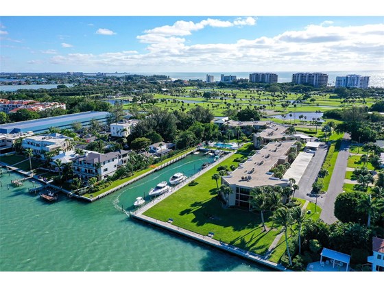 South west views of Bay Harbour.  Longboat Key Club Golf Court across Gulf of Mexico Drive and the Gulf just beyond. Dry Dock restaurant and Gas dock, to the left. - Condo for sale at 450 Gulf Of Mexico Dr #B107, Longboat Key, FL 34228 - MLS Number is A4520786