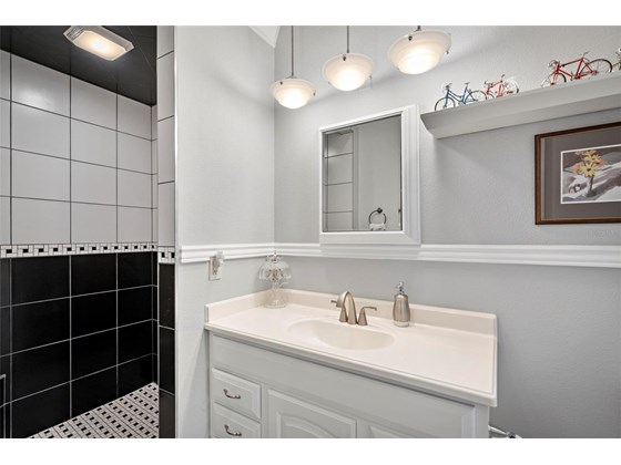 The first floor master bath features a walk-in shower - Single Family Home for sale at 1012 Bayview Dr, Nokomis, FL 34275 - MLS Number is A4521028